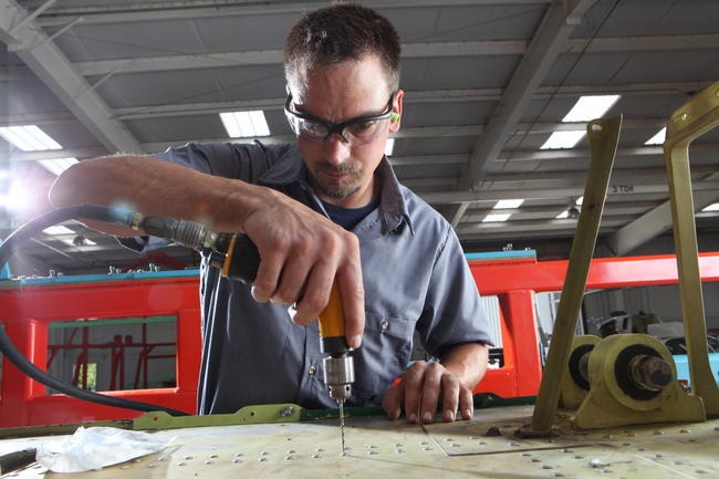 Arrow helicopter technician working on engineering project